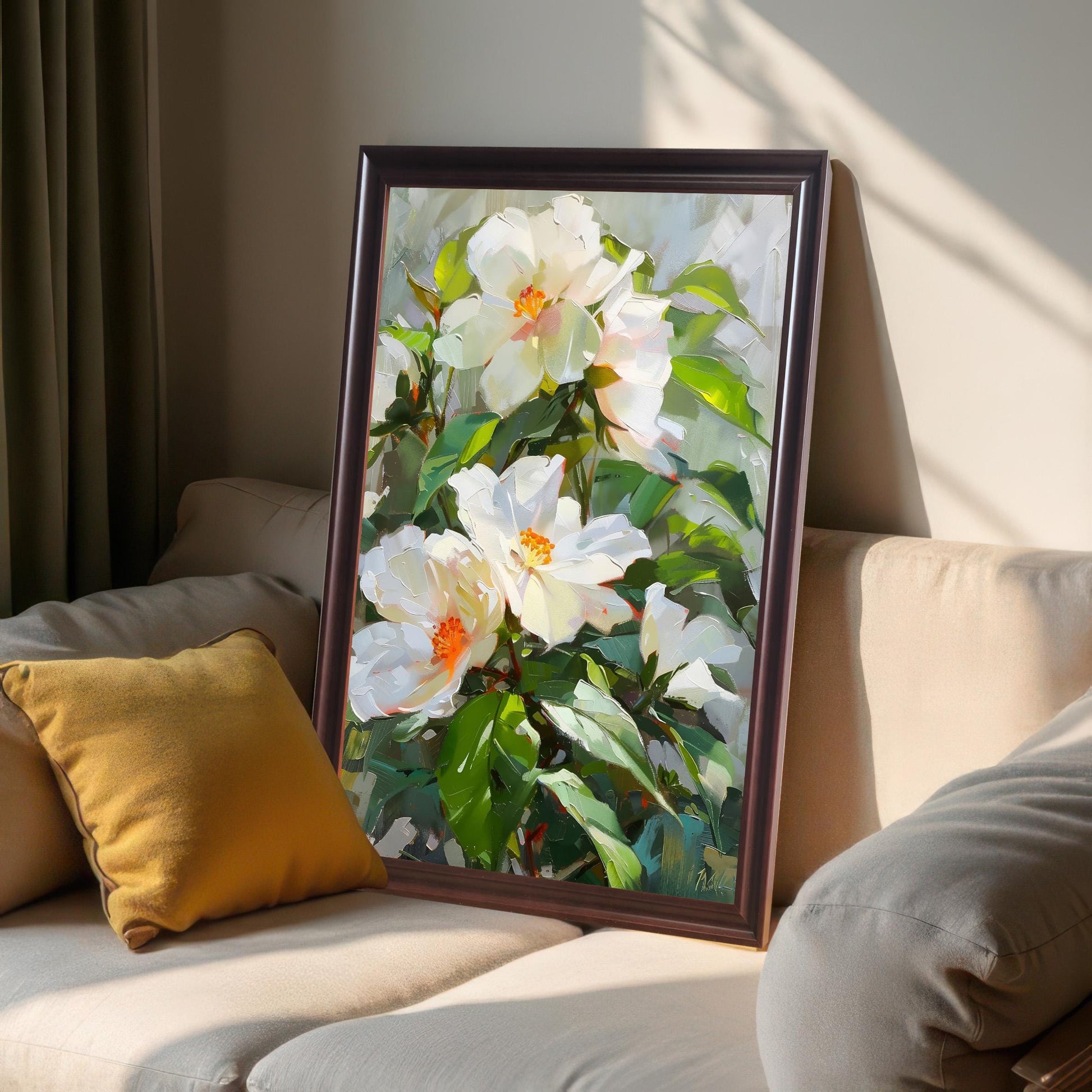 Oil painting print of white flowers, framed in Coffee wood, leaning on a beige sofa cushion in soft sunlight.