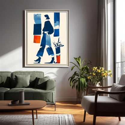 Large framed abstract art print in a white/light frame hanging above a dark green sofa in a modern living room setting with natural light and house plants.
