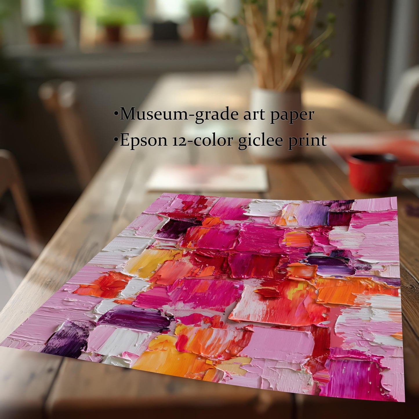 Close-up, low-angle shot of the unframed abstract oil-style art print lying on a wooden table. Text overlay highlights the materials: ""Museum-grade art paper"" and ""Epson 12-color giclee print.""