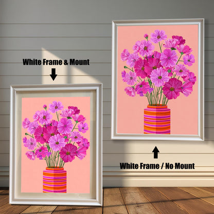 Comparison image showing the Cosmos flower print with a White Frame & Mount (matting) on the left, and a White Frame / No Mount on the right, against a white paneled wood wall.