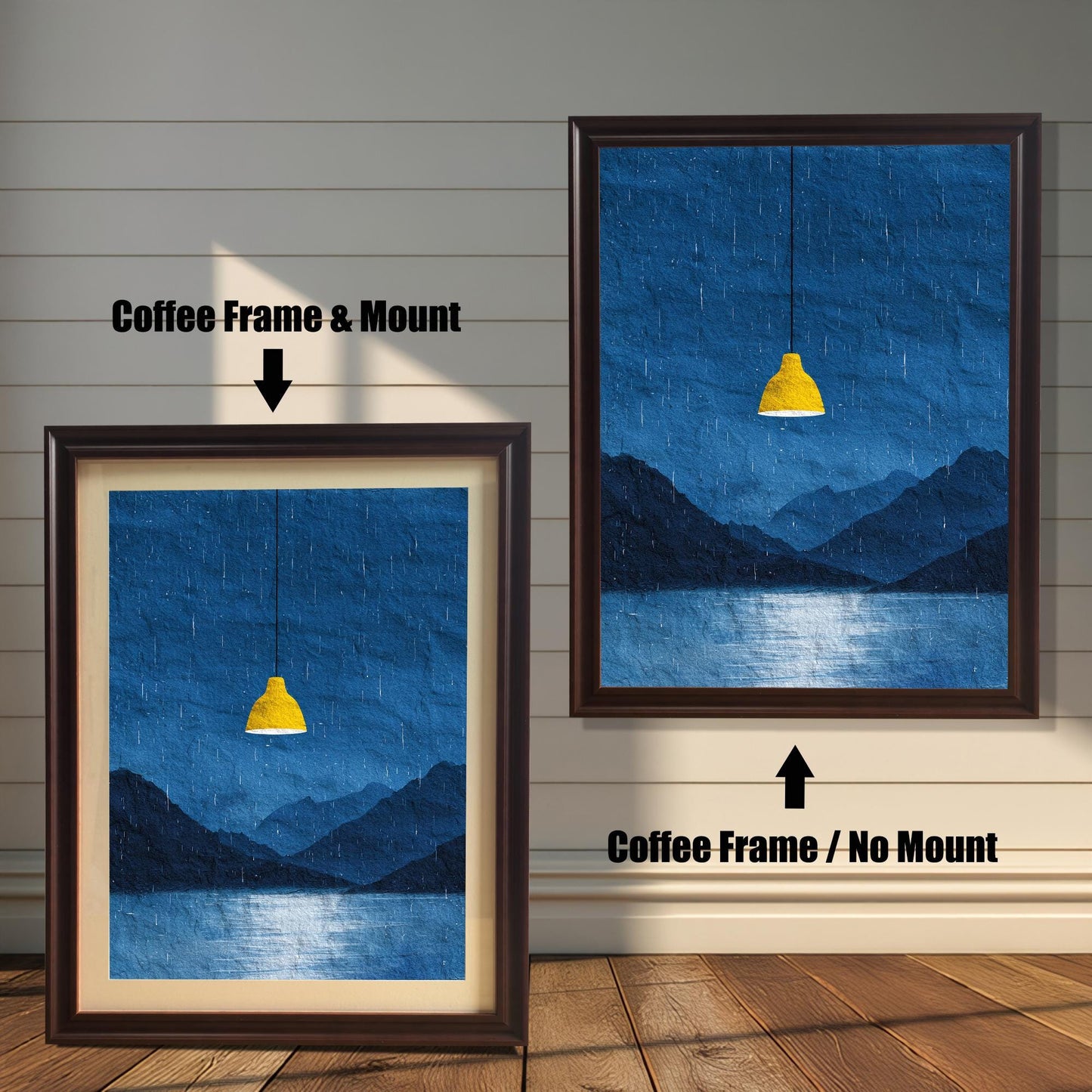 A comparison image showing two framed art prints on a wooden wall. The print on the left is in a Coffee Frame & Mount (dark brown frame with a light mat). The print on the right is in a Coffee Frame / No Mount (dark brown frame, no mat). Both feature the dark blue rainy landscape with the yellow lamp.