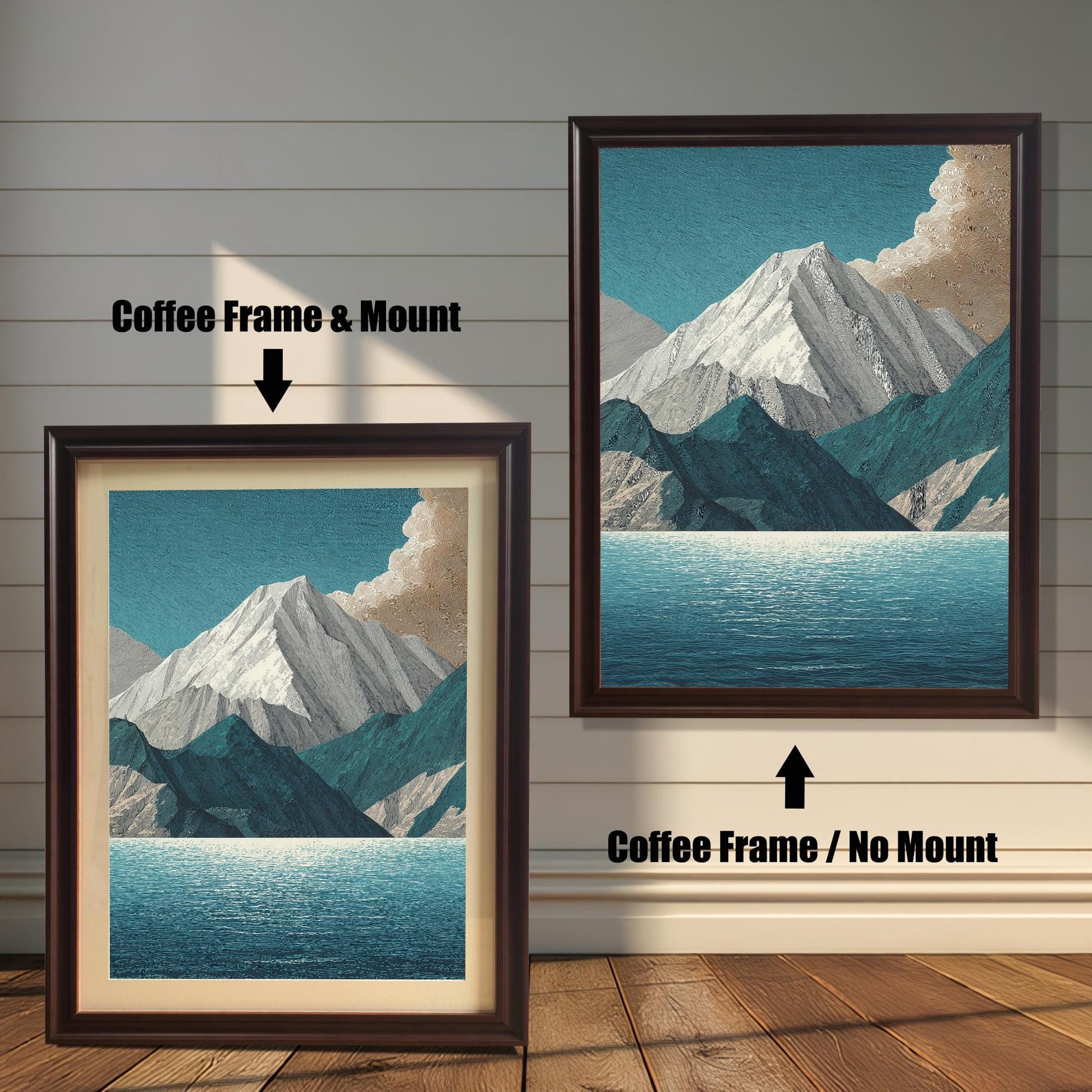A comparison image showing two framed art prints on a wooden wall. The print on the left is in a Coffee Frame & Mount (dark brown frame with a light mat). The print on the right is in a Coffee Frame / No Mount (dark brown frame, no mat). Both feature the mountain and lake design.