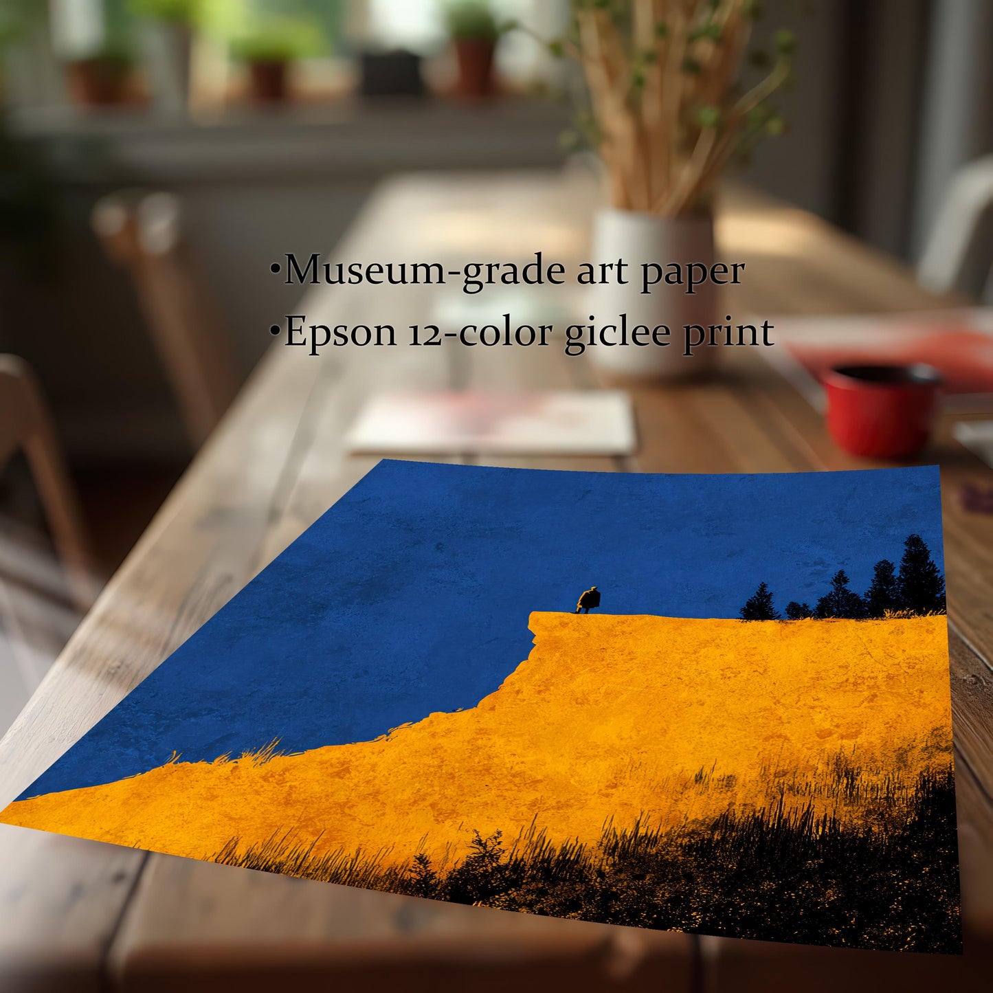 Detail image of the art print (unframed) featuring the yellow cliff and blue sky design, lying on a wooden table. Text highlights the quality: Museum-grade art paper and Epson 12-color giclee print."