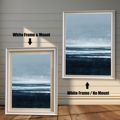 Comparison image showing the White frame options: on the left, a framed seascape print with a mount/mat; on the right, the print in a white frame with no mount. Both on a white paneled wooden wall background.