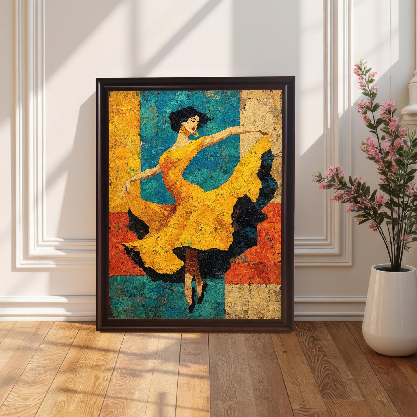 A framed art print of a dancer in a yellow dress, set in a Coffee/Dark Brown Frame (no mount), propped on a hardwood floor against a white paneled wall with a potted plant to the side. Sunlight casts diagonal shadows across the floor.