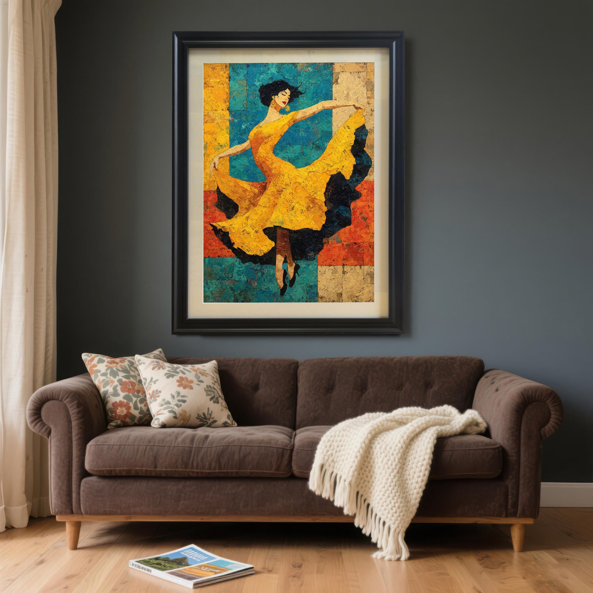 The framed dancer art print with a Black Frame and White Mount hangs prominently over a dark brown, two-seater sofa against a dark gray wall. A cream-colored knitted throw blanket and two throw pillows are on the couch.