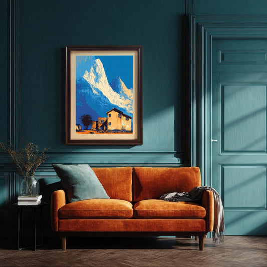 Large landscape art print in a dark wood frame with a mount, hanging above an orange velvet sofa against a dark teal paneled wall.