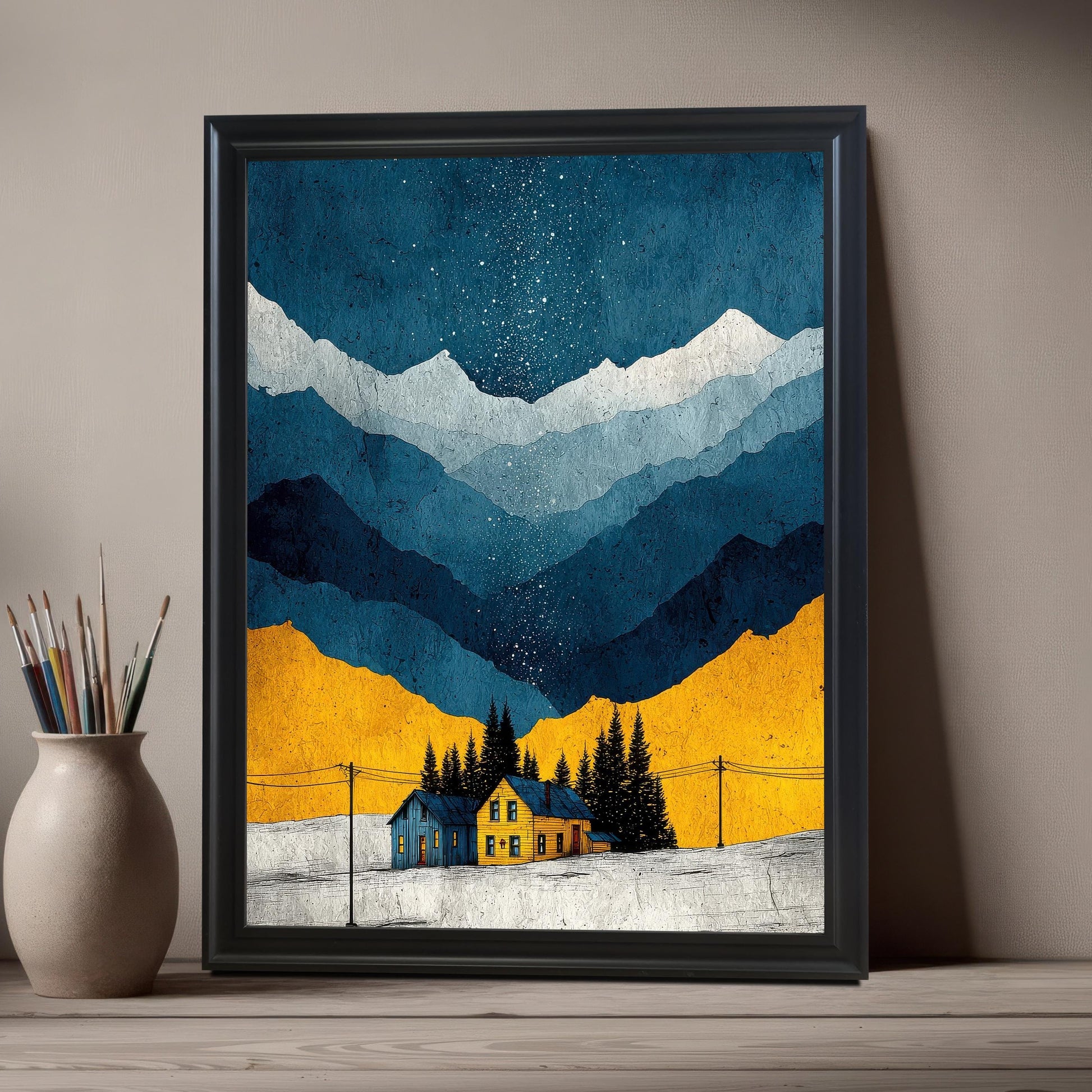 A close-up of the art print in a Black Frame / No Mount (full bleed print) leaning on a light wooden surface next to a vase holding various paintbrushes.