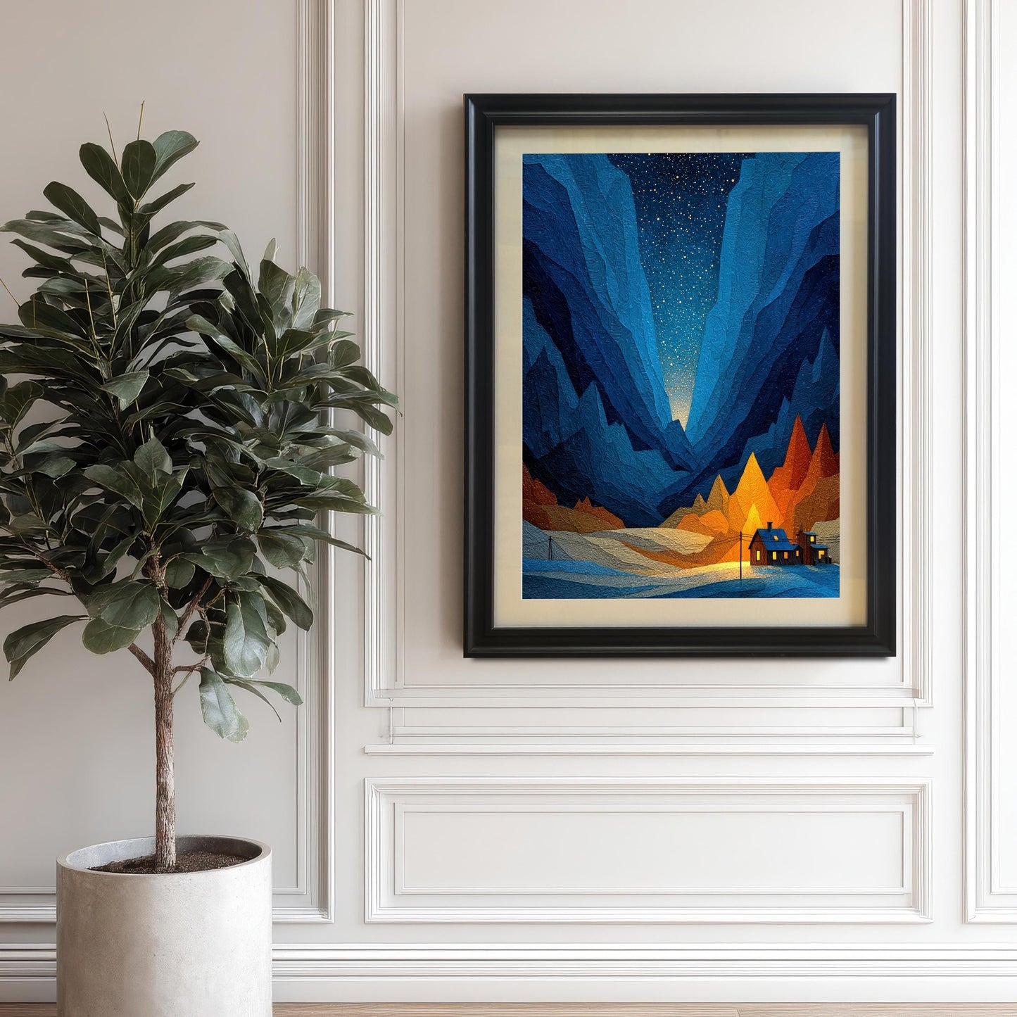 The geometric art print in a Black Frame with a mat/mount hanging on a white paneled wall next to a large potted plant (ficus lyrata/fiddle-leaf fig).