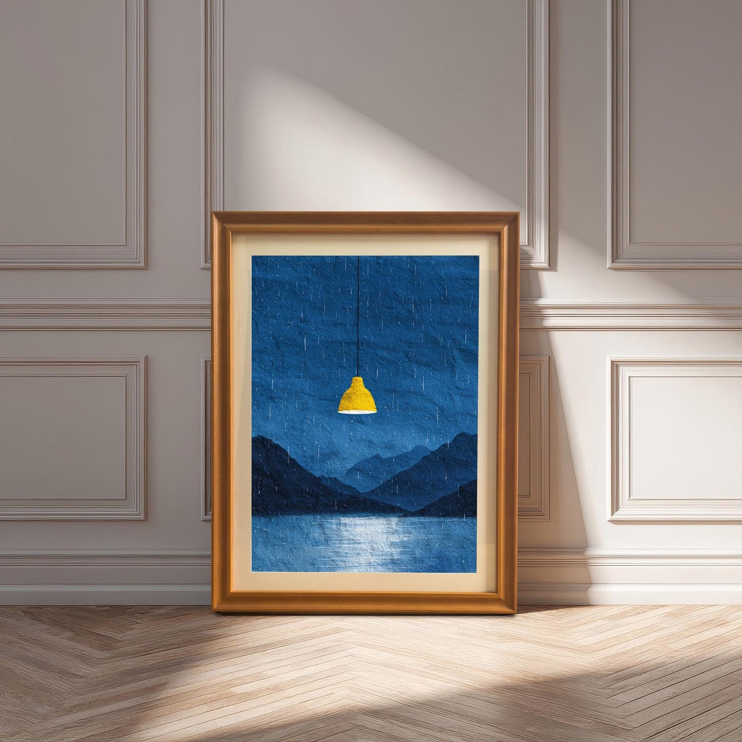 A framed art print of the dark blue rainy landscape with the yellow lamp in an Orange (golden/bronze) frame with a mount, leaning against a white wainscoting wall on a herringbone floor. Sunlight creates deep shadows.