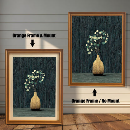 A side-by-side comparison of the golden vase and eucalyptus art print framed in an Orange Frame. The image on the left shows the print with a mount (matting), and the image on the right shows it without a mount.