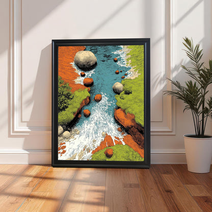 A framed art print in a black frame, leaning on a wooden floor against a white paneled wall (wainscoting). The artwork is a colorful, stylized illustration of a river rushing between rocky, green banks. Sunlight casts long, dramatic shadows. A potted green plant sits to the right.