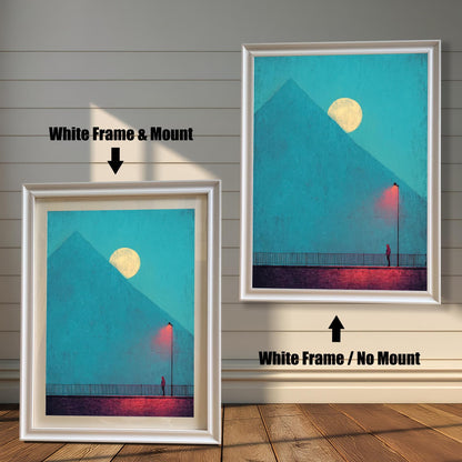 Comparison image showing two framed art prints against a white wainscoting wall. The left print uses a White Frame & Mount (matting). The right print uses a White Frame / No Mount. The art depicts a minimal landscape with a figure, a red lamp post, and a pyramid under a moon.