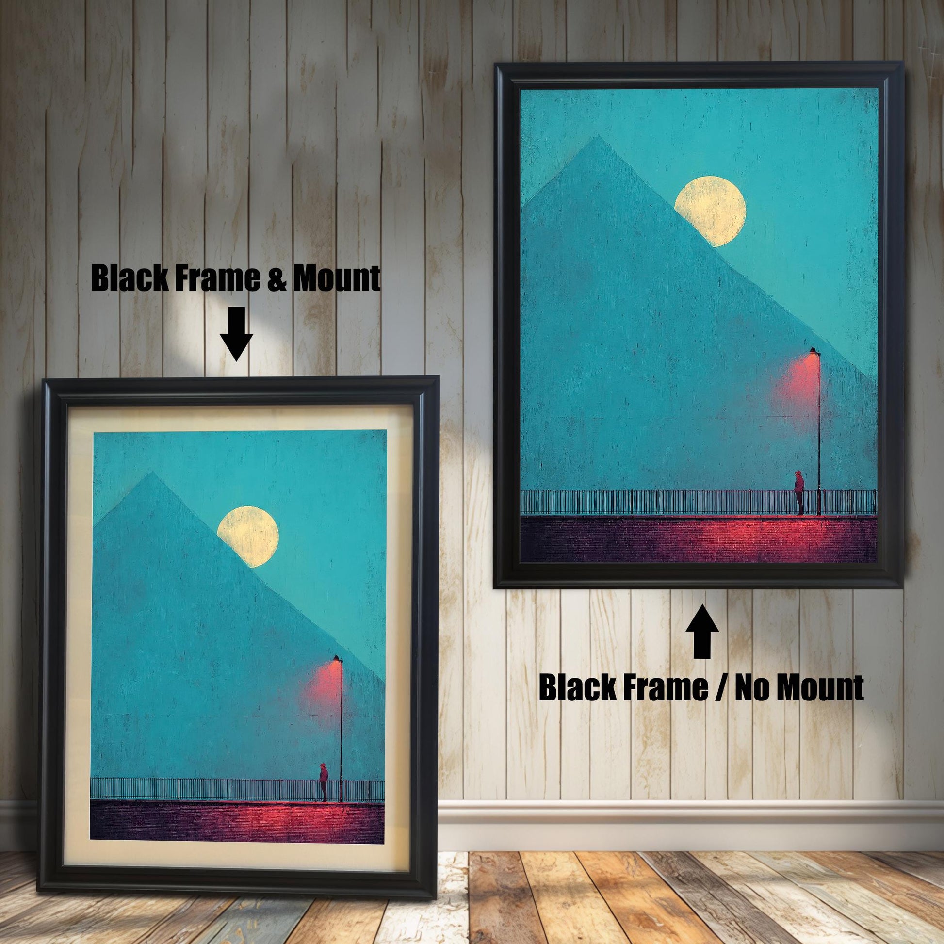 Comparison image showing two framed art prints against a white wainscoting wall. The left print uses a Black Frame & Mount (matting). The right print uses a Black Frame / No Mount. The art depicts a minimal landscape with a figure, a red lamp post, and a pyramid under a moon.