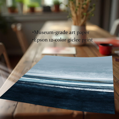 Detail image of the abstract seascape art print (unframed) lying on a wooden table, emphasizing the deep blues and whites. Text highlights the quality: Museum-grade art paper and Epson 12-color giclee print.