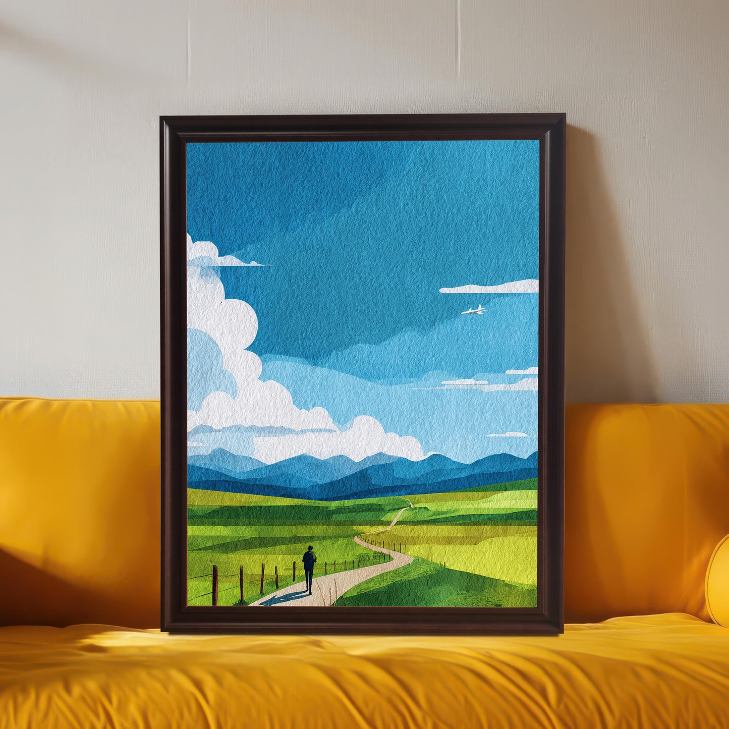 Large framed art print of the abstract green field landscape, displayed in a Coffee (dark brown) frame leaning on a bright yellow sofa. The background wall is light gray. Shows the print used as maximalist or colorful decor.