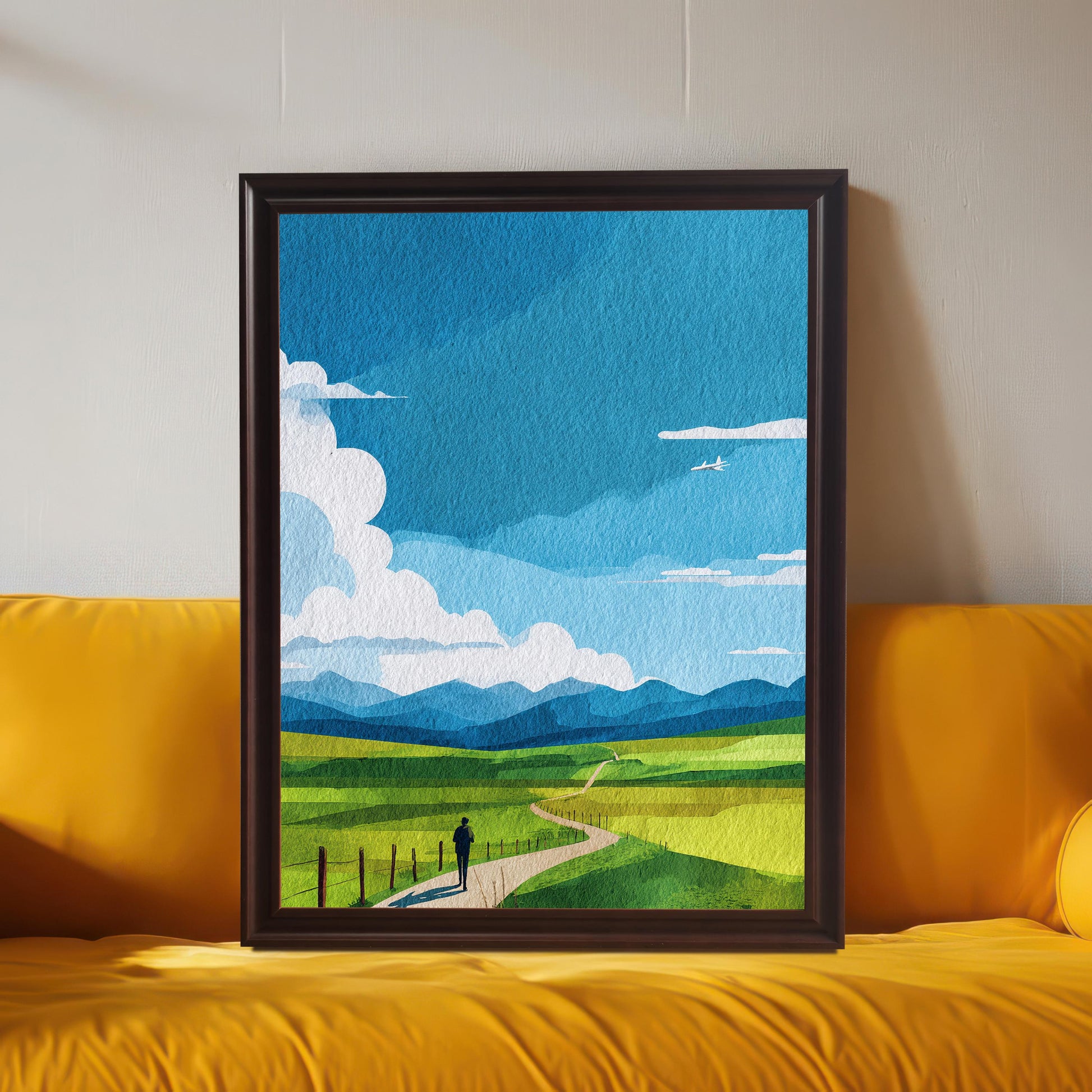 Large framed art print of the abstract green field landscape, displayed in a Coffee (dark brown) frame leaning on a bright yellow sofa. The background wall is light gray. Shows the print used as maximalist or colorful decor.