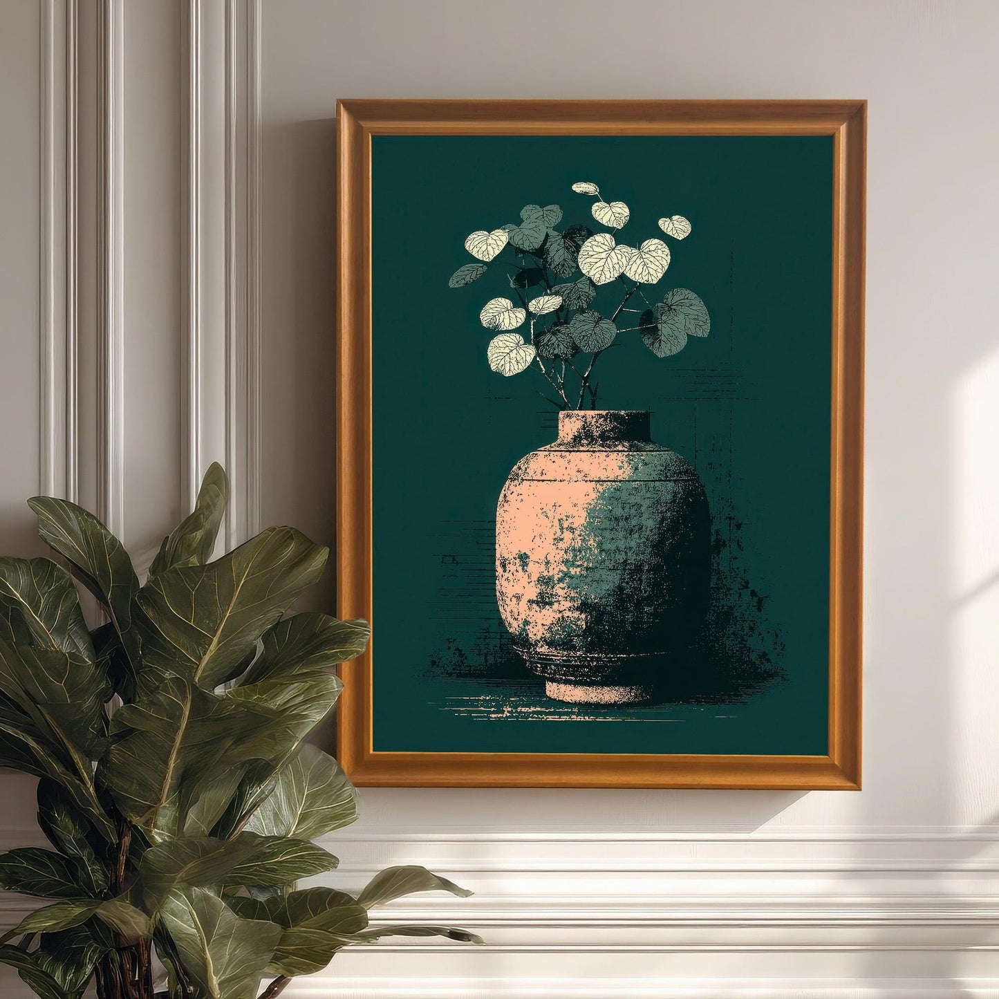 A framed art print of a vase illustration hanging on a classic white wainscoted wall, next to a large potted plant. The frame is Orange (light brown wood color).