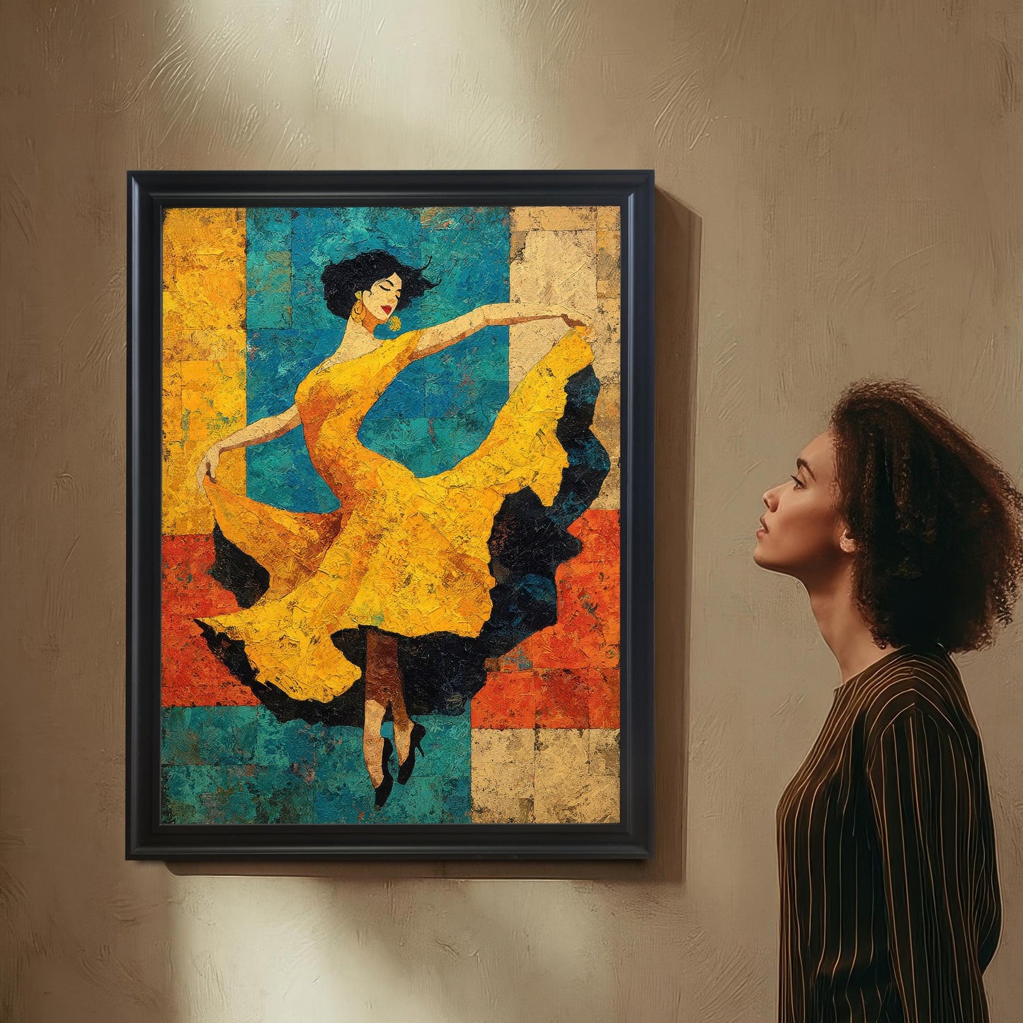 A young woman with curly hair, wearing a striped shirt, looks up thoughtfully at the framed dancer art print hanging on a textured tan wall. The print has a Black Frame and no mount.
