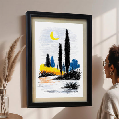 A woman with glasses is admiring an abstract landscape print hanging on a pale pink wall. The print, styled like a crayon drawing with black cypress trees, yellow and blue shrubs, and a crescent moon, is framed in black with a white mount. Dried wheat stalks are visible in a vase to the left.