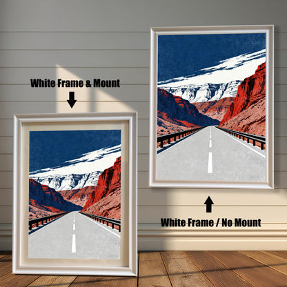 A side-by-side comparison of a framed art print. The image on the left has a White Frame & Mount (a white border or matting) and the image on the right has a White Frame / No Mount. The art depicts a long, straight road through red rock canyons under a dark blue and white sky.