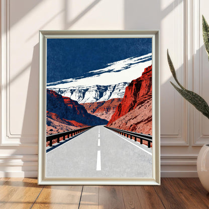 A framed art print with a white frame, leaning against a white wainscoted wall on a wooden floor. The print is bathed in sunlight and shadow, and a large potted snake plant is visible on the right.