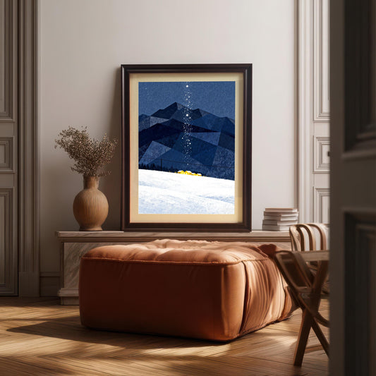 Framed art print with dark blue geometric mountains, a snowy slope, and a trail of stars, displayed on a marble console above a brown leather ottoman in a sunlit living room.