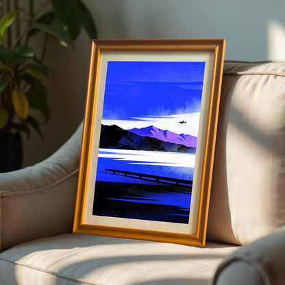 Blue Lake/Mountain	Framed Blue Lake/Mountain art print in an Orange Frame with a mount, resting on a beige armchair in sunlight next to an indoor plant.