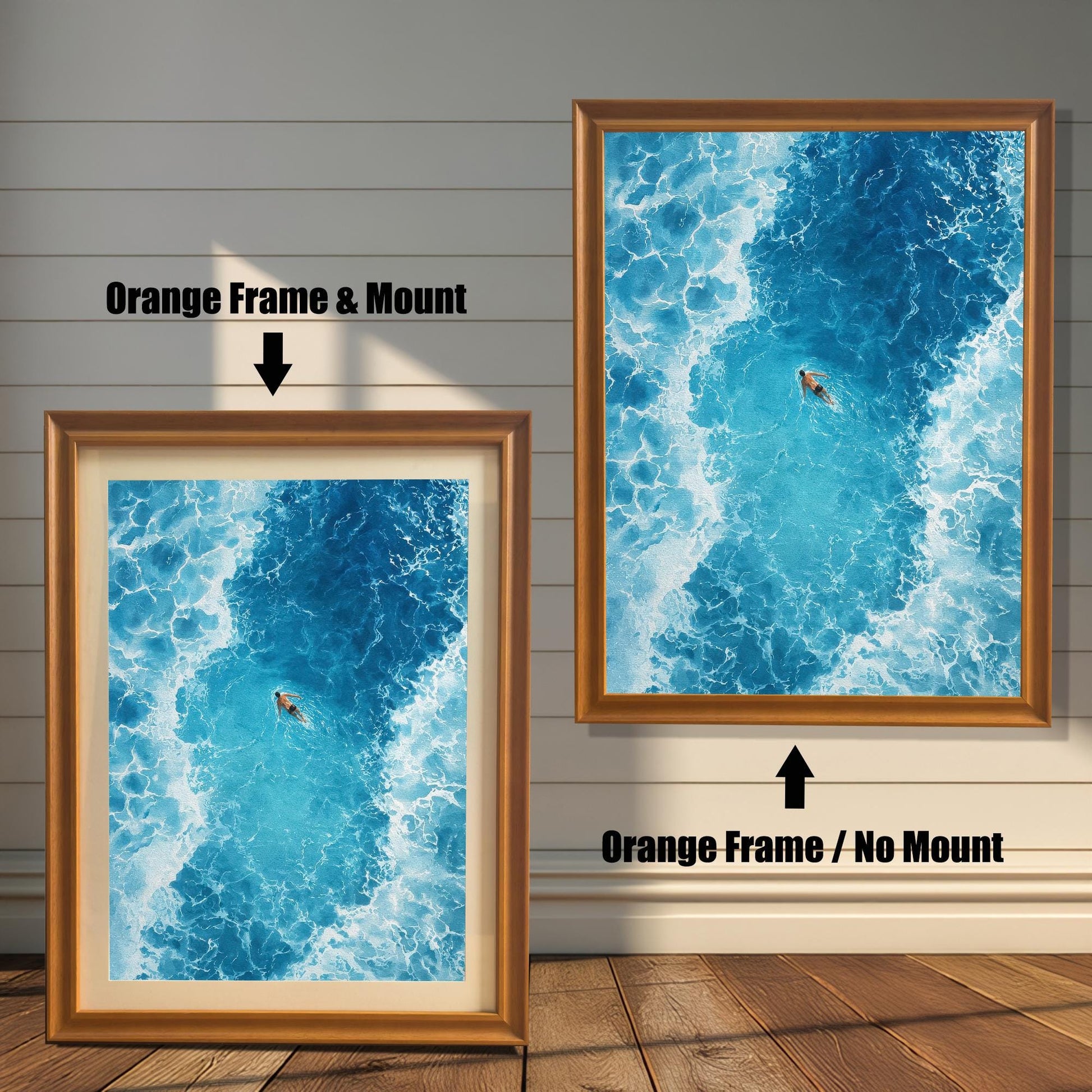 Comparison of the ocean art print with an Orange frame. The image on the left has a 'Mount' (mat board) and is leaning against the wall. The image on the right is hanging and has 'No Mount'. Both have an Orange/light brown wood frame.