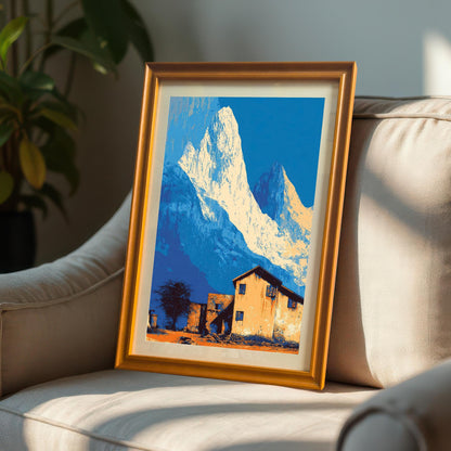 Landscape art print in an orange/light brown wood frame with a mount, propped up on a textured, neutral-colored armchair.