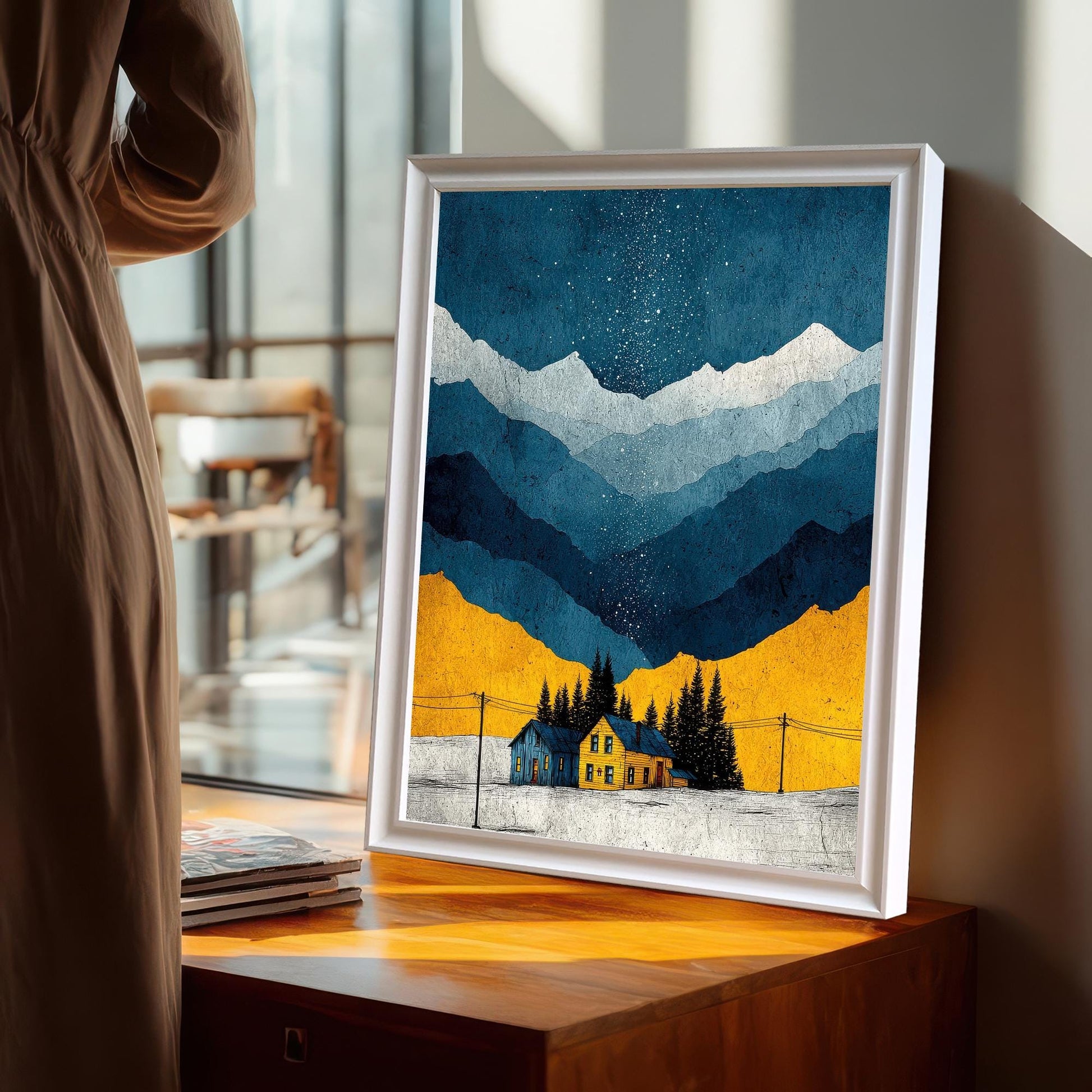 The art print in a White Frame / No Mount (full bleed print) leaning on a wooden table near a window, with a person in a neutral-colored dress standing in the foreground.