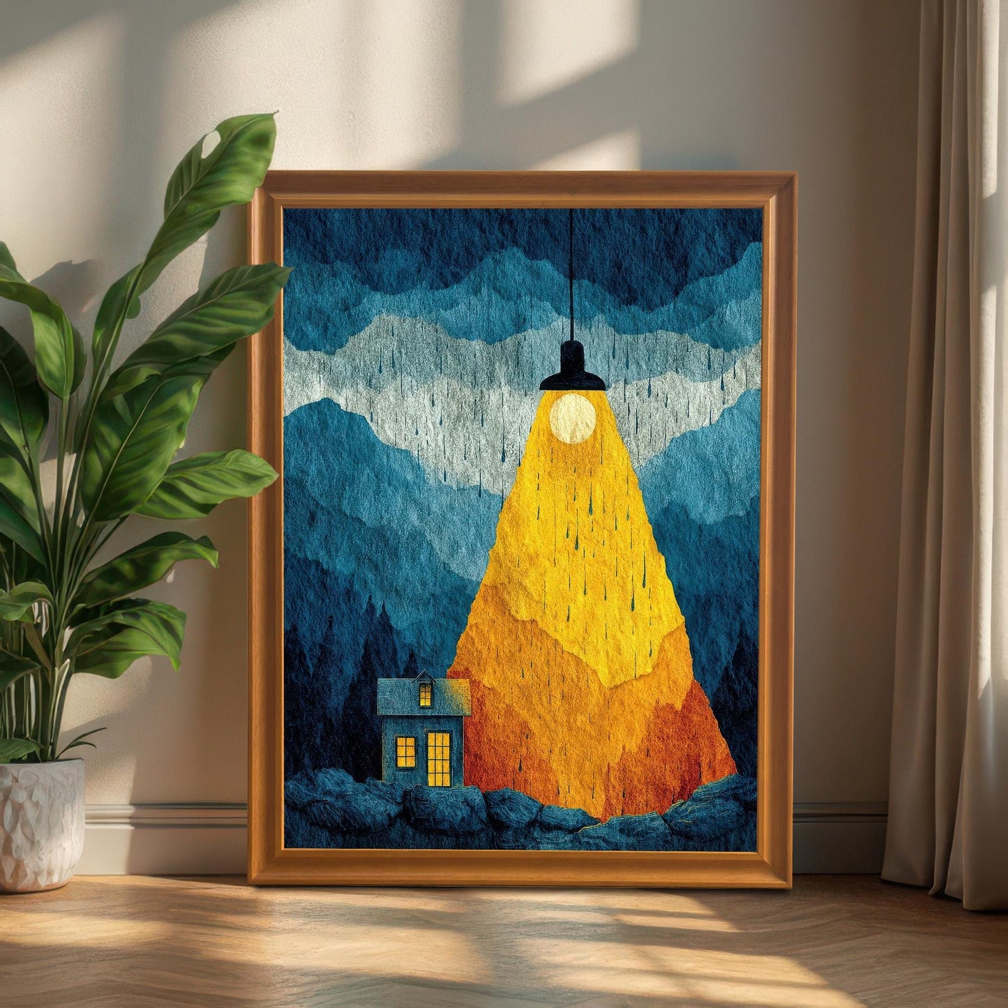 Large "Spotlight House" art print in an Orange wood frame leaning against a neutral wall on a hardwood floor next to a green potted plant.