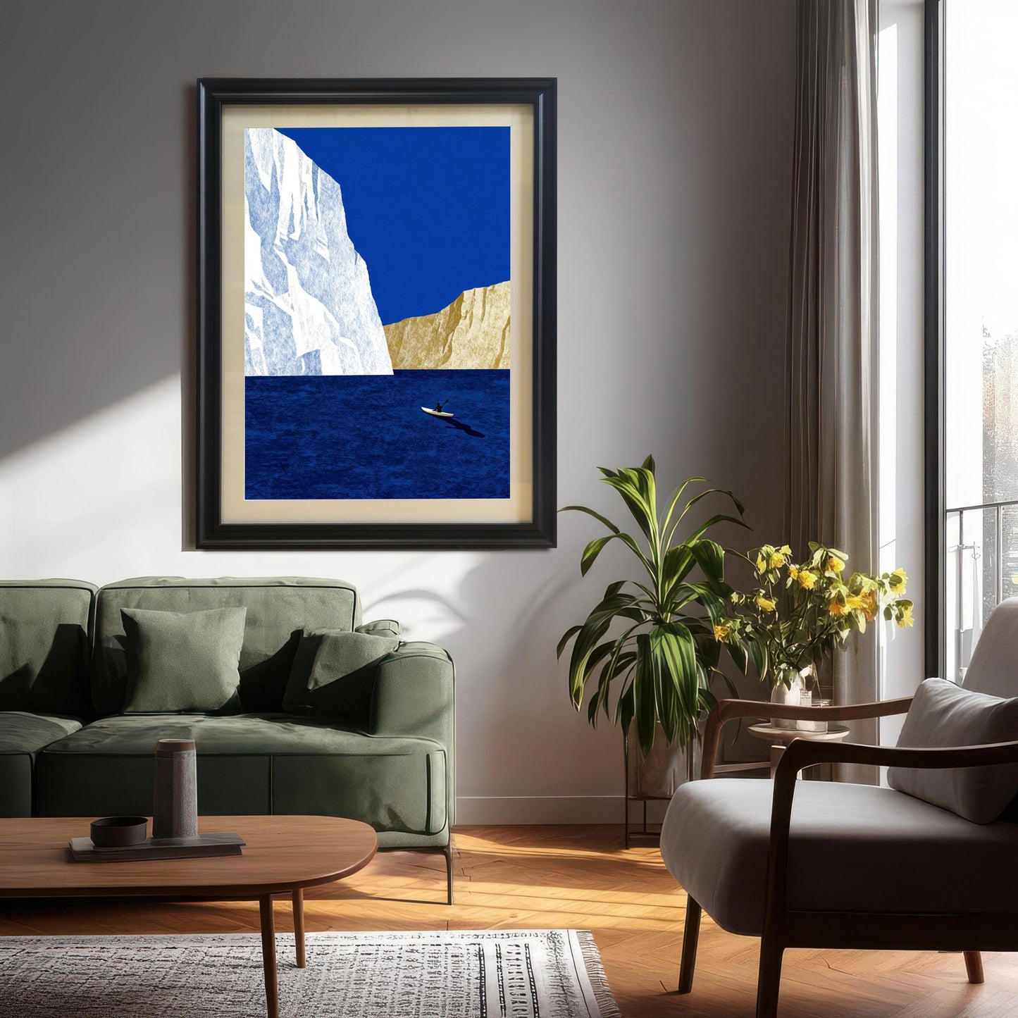 Minimalist landscape art print featuring a blue ocean and white iceberg, in a black wood frame hanging above a green sofa in a modern living room.
