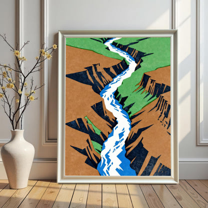 A white-framed version of the abstract canyon print without a mount, displayed on a light wooden floor next to a white vase with delicate yellow flowers against a paneled white wall.