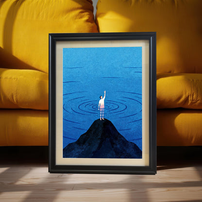 A black wood-framed print with an off-white mat (mount) leaning against a bright yellow plush sofa on a light-colored wooden floor. The scene is illuminated by dramatic natural sunlight, highlighting the contrast between the vibrant yellow furniture and the deep blue tones of the minimalist illustration.