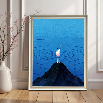 A vertical white wood-framed print without a mount, leaning against a classic white paneled wall on a light wood floor. To the left, a tall white ceramic vase holds a delicate flowering branch, creating a clean, bright, and modern aesthetic for the blue water artwork.
