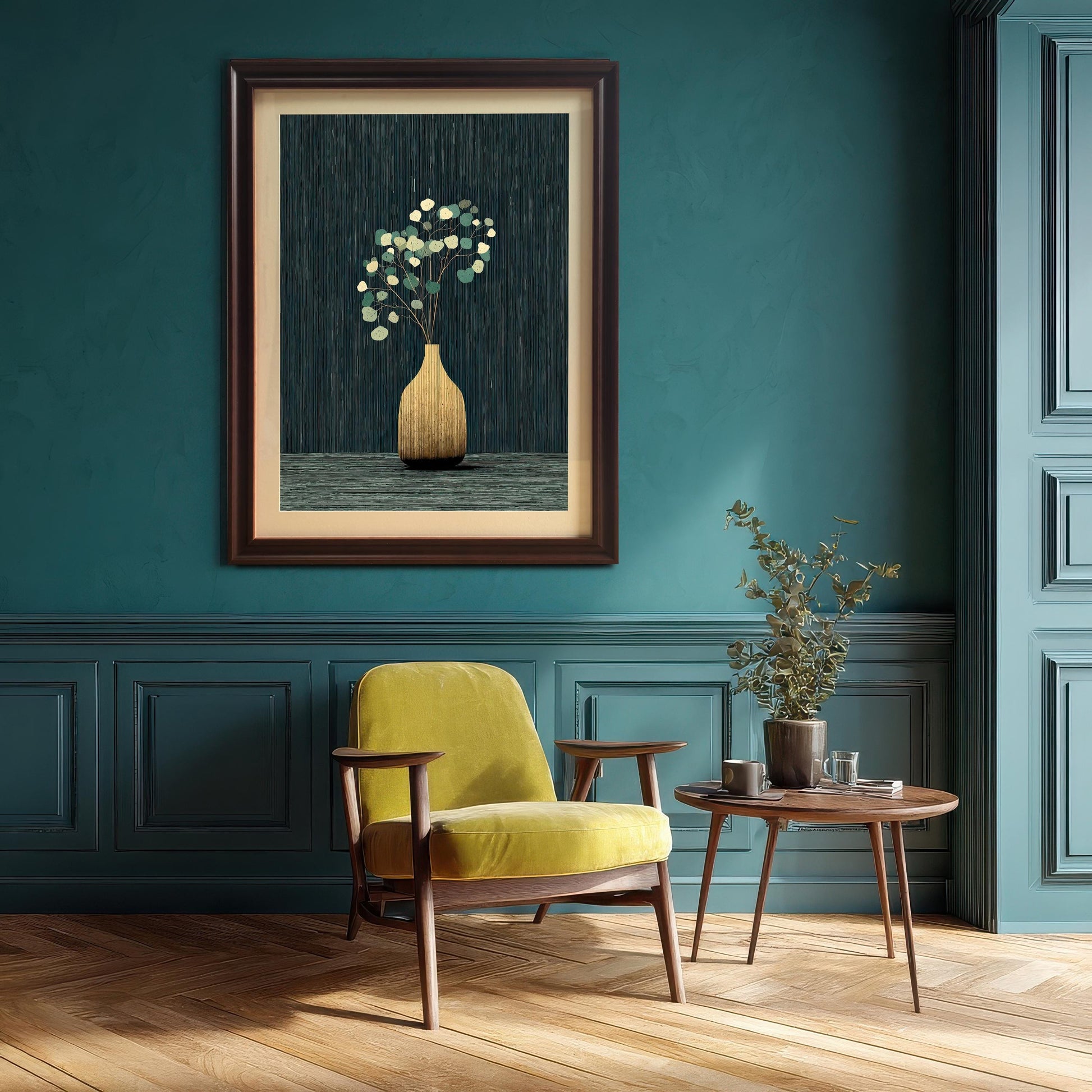 A framed art print depicting a golden vase with stylized eucalyptus leaves on a dark blue/teal textured background, hanging on a teal paneled wall above a yellow armchair and a small wooden side table.