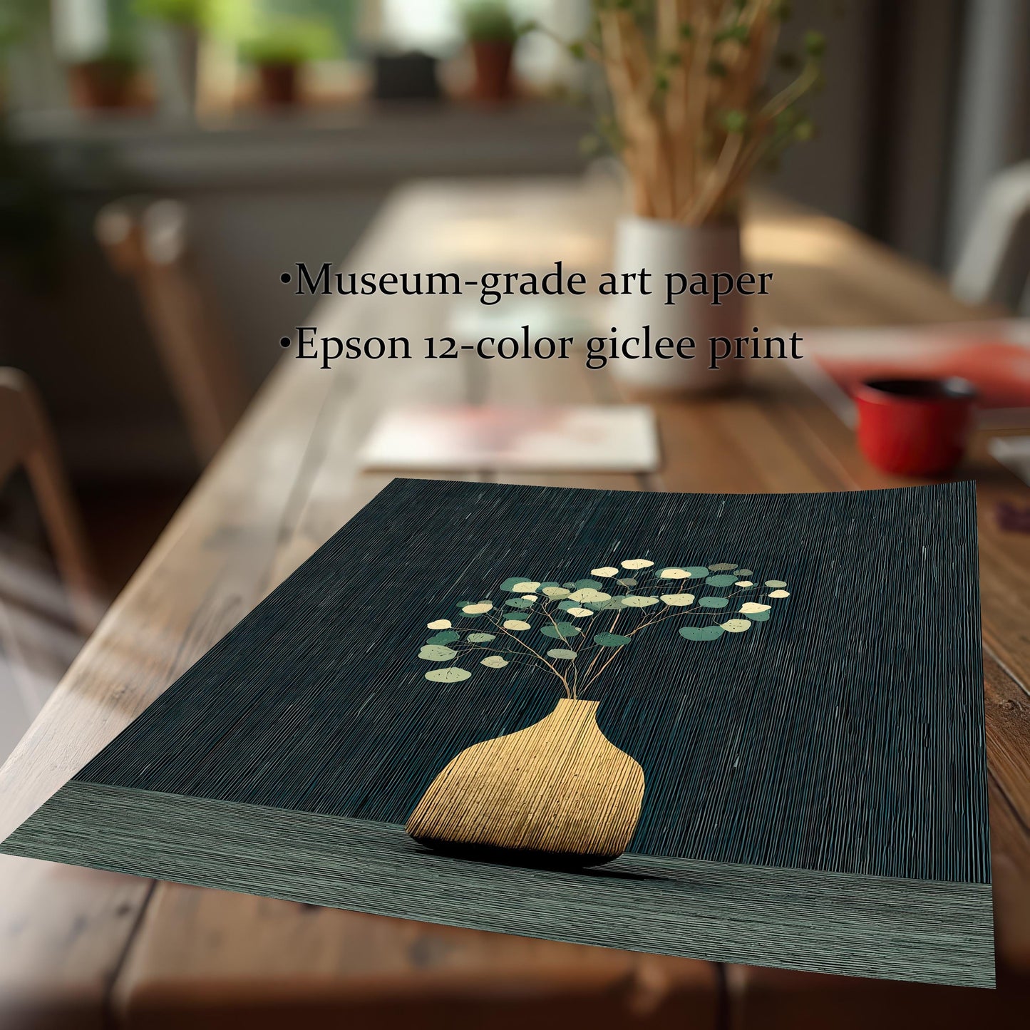Close-up shot of the golden vase and eucalyptus art print on a wooden table. Text overlay lists: ""Museum-grade art paper"" and ""Epson 12-color giclee print.""