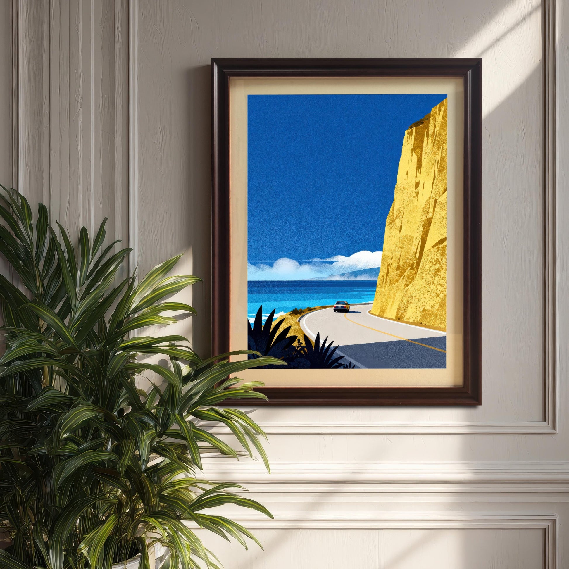 A coffee-brown wood-framed art print with a mat board hung on a decorative wainscoted wall next to a lush green indoor plant.