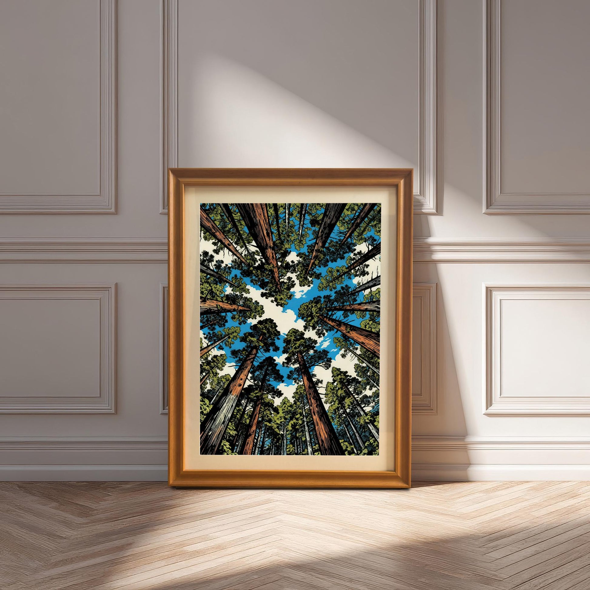 Large orange wood framed redwood tree art print with a white mount, resting on a herringbone wood floor in a bright, sunlit room.