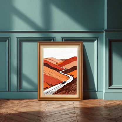 A medium-shot of the orange-framed landscape art print leaning against a teal-colored wainscoted wall on a hardwood parquet floor.
