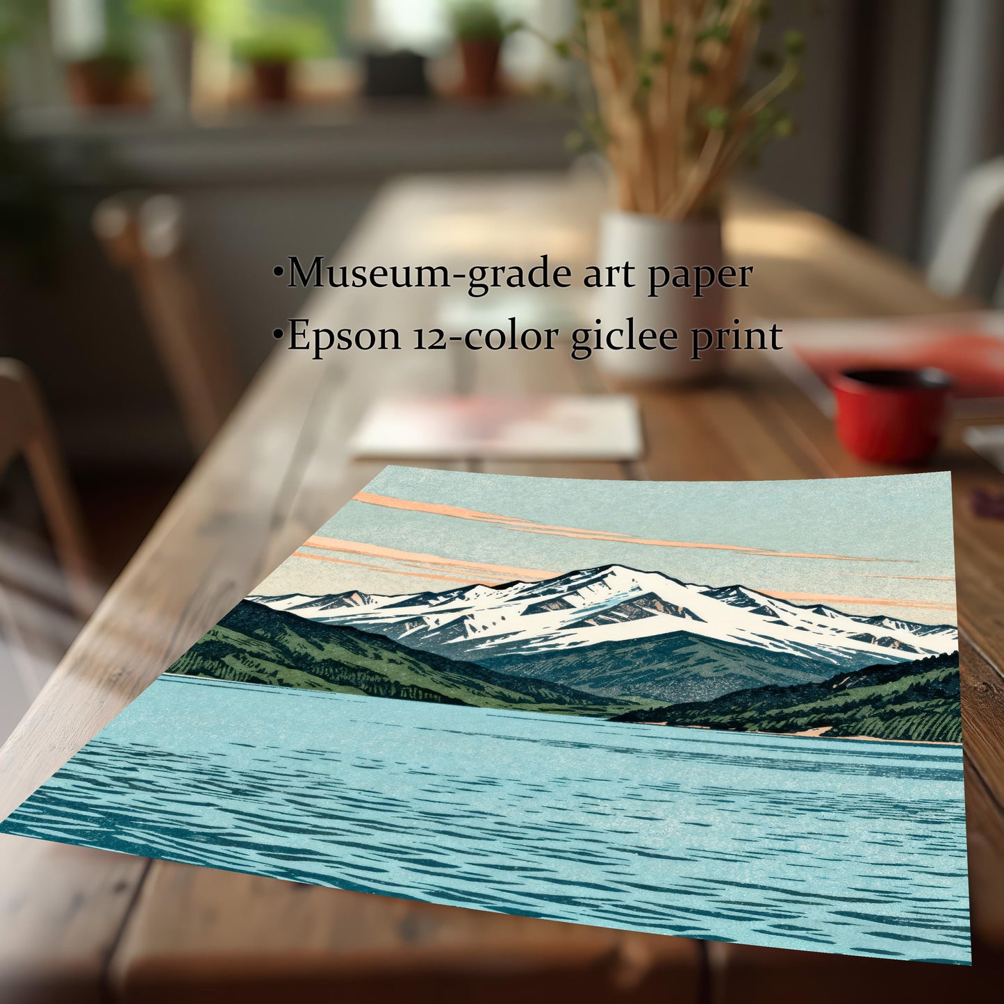 A close-up, angled view of the mountain art print on museum-grade textured paper, highlighting the high-quality 12-color giclee printing detail on a wooden table.