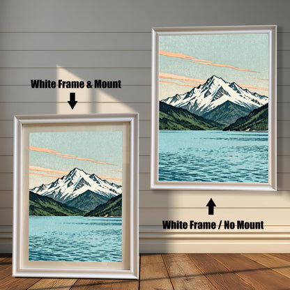 Two side-by-side examples of the mountain landscape print in white wood frames; the left version includes a mat board (mount) and the right version is shown without a mount.