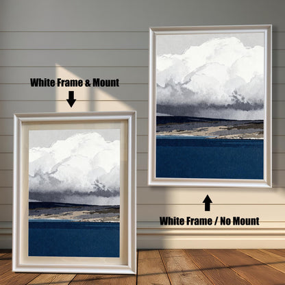 A side-by-side comparison of the blue and white landscape art in a sleek white wood frame; the left side features a white mat mount, and the right side shows the print without a mount.