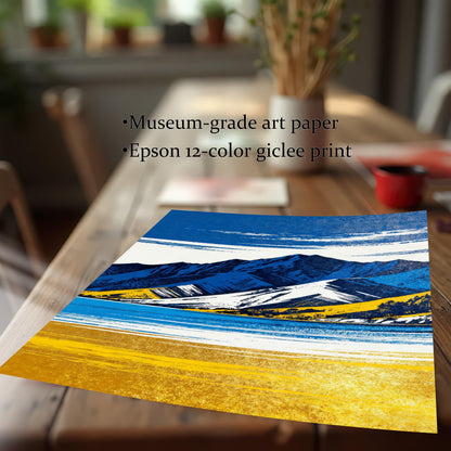 A close-up, angled view of an unframed print of the blue and yellow mountain landscape, lying on a wooden table. Text highlights the quality: "Museum-grade art paper" and "Epson 12-color giclee print".