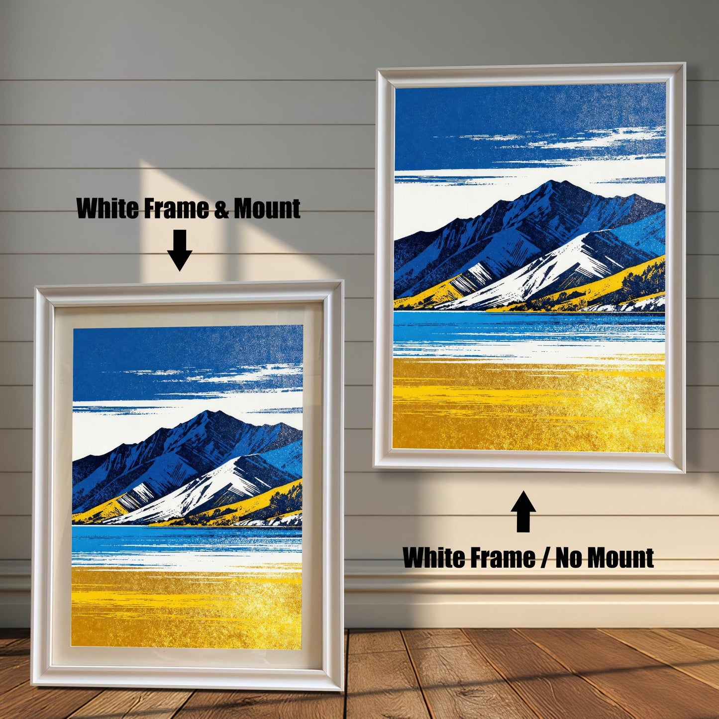 Two framed art prints on a white shiplap wall. Both prints feature the same blue and yellow mountain landscape. The left print shows the art in a White Frame & Mount (matting). The right print shows the art in a White Frame / No Mount.