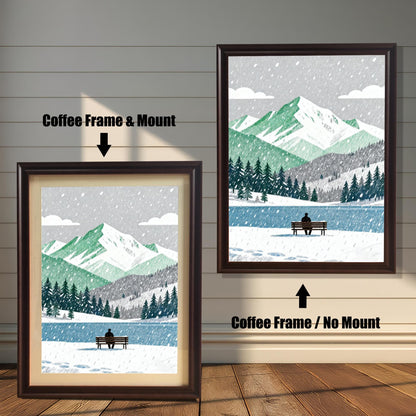 A wood framed art print of a snowy mountain and lake scene. The image shows two framing options: Coffee Frame with a Mount (left, smaller) and Coffee Frame without a Mount (right, larger). A person sits on a bench by the lake.