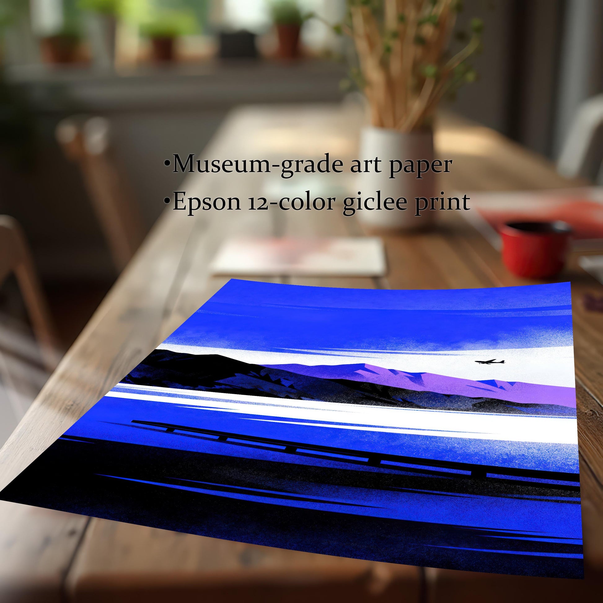 Blue Lake/Mountain	Close-up of the print on a wooden table, showing a vibrant blue and purple stylized lake/mountain landscape with a small airplane. Text reads: "Museum-grade art paper," "Epson 12-color giclee print."