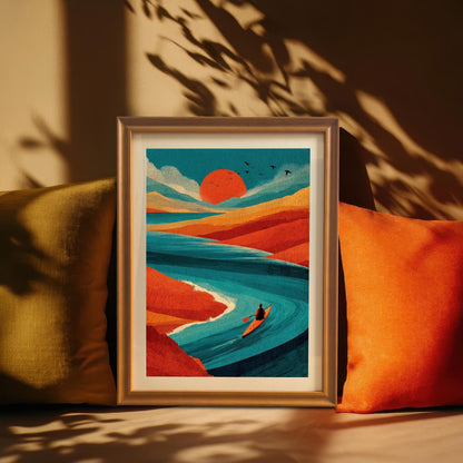 Framed landscape art print sitting on a shelf between yellow and orange pillows, illuminated by natural sunlight and leaf shadows.