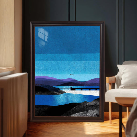A large "Coffee" brown wood-framed art print leaning against a dark navy textured wall in a modern room with a herringbone wood floor and a white armchair.